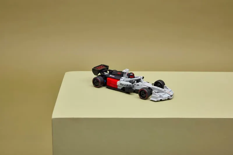 The assembled LEGO Audi Revolut F1 Team R26 Race Car 77259 displayed on a light-colored pedestal, emphasizing its display quality.