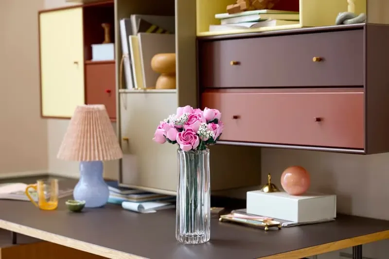 Roses on desk, colorful room.