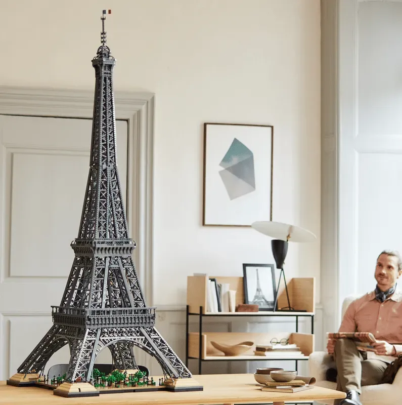 Man admiring completed LEGO Eiffel Tower.