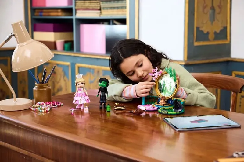 Girl building Lego Elphaba & Glinda backdrop.