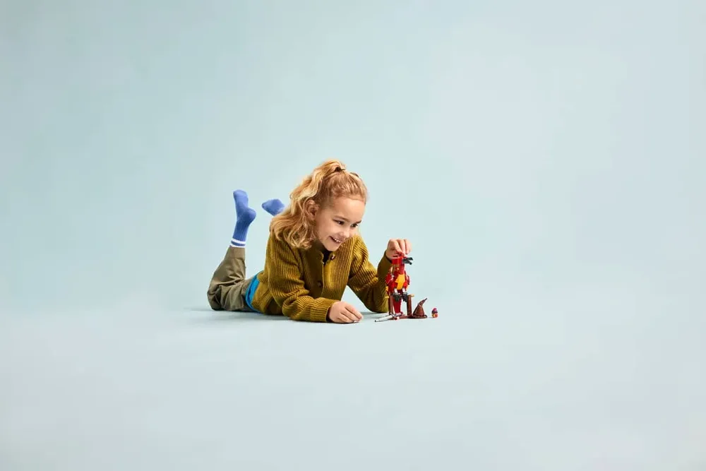 Child playing with the Fawkes LEGO set.