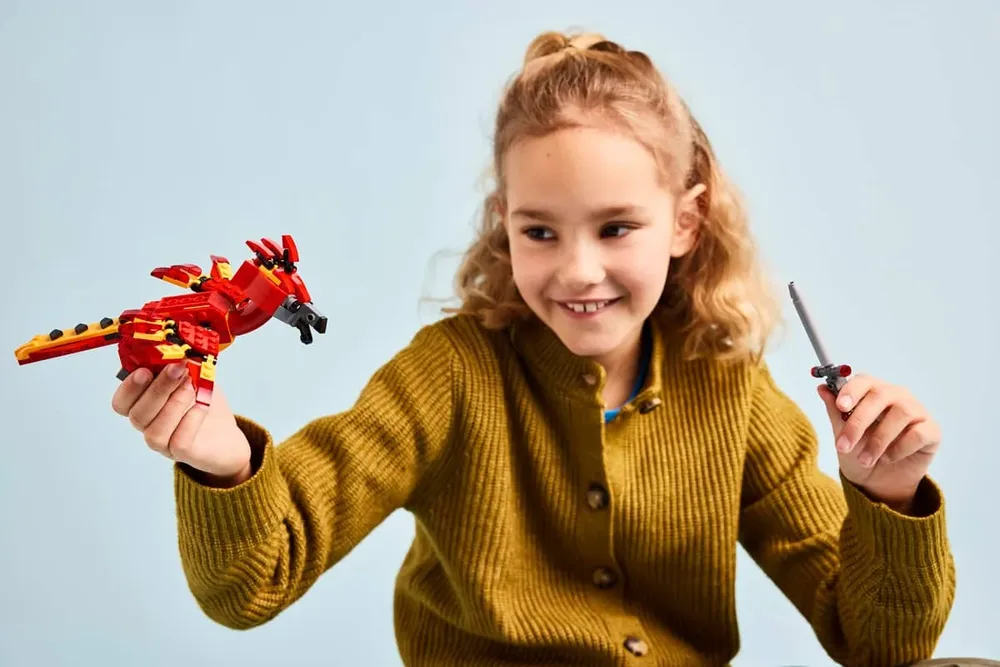 Child holding Fawkes and the Sword of Gryffindor.
