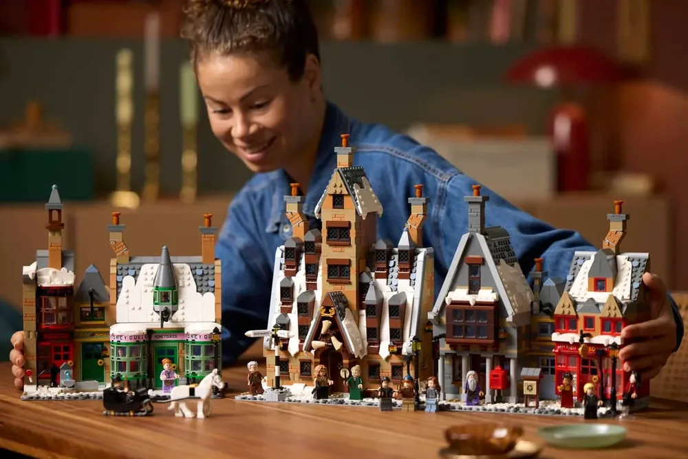 Person admiring Hogsmeade Village set.