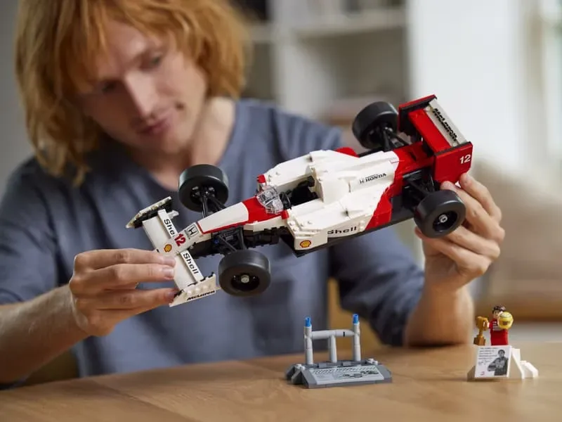 Person holding Lego McLaren MP4/4 model.