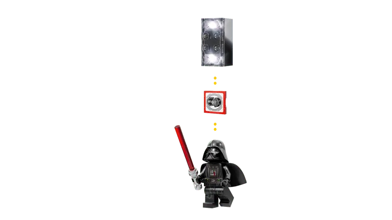 A diagram showing the LEGO Smart Brick glowing white, positioned above a red Smart Tag with a TIE Fighter symbol, which is then above a Smart Darth Vader minifigure holding a red lightsaber, illustrating their interconnectedness.