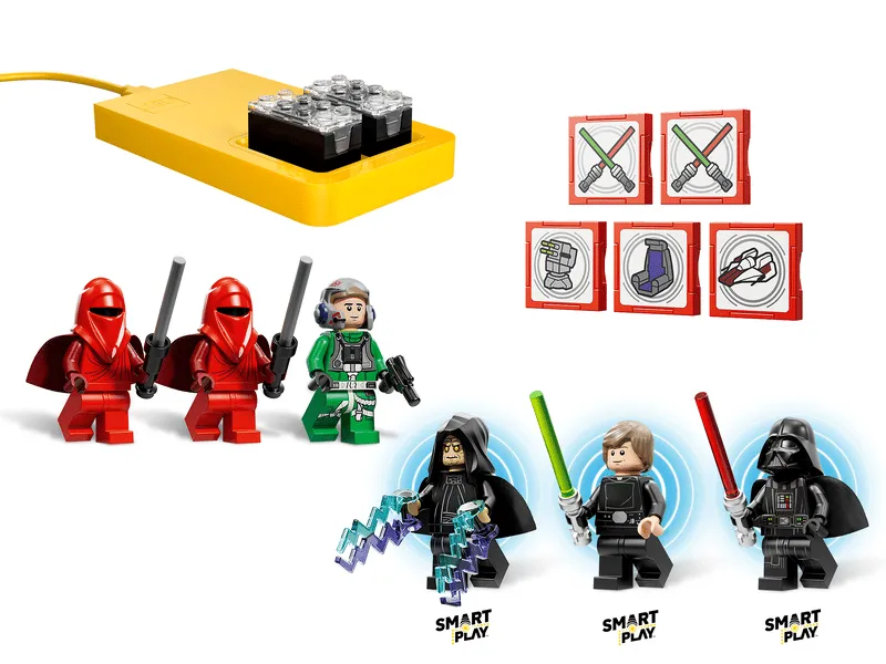 Close-up of LEGO Star Wars 75427 Smart Play components: a yellow Smart Brick charger, interactive game cards, and minifigures (Royal Guards, A-Wing pilot, Emperor Palpatine, Luke Skywalker, Darth Vader) with Smart Play labels.