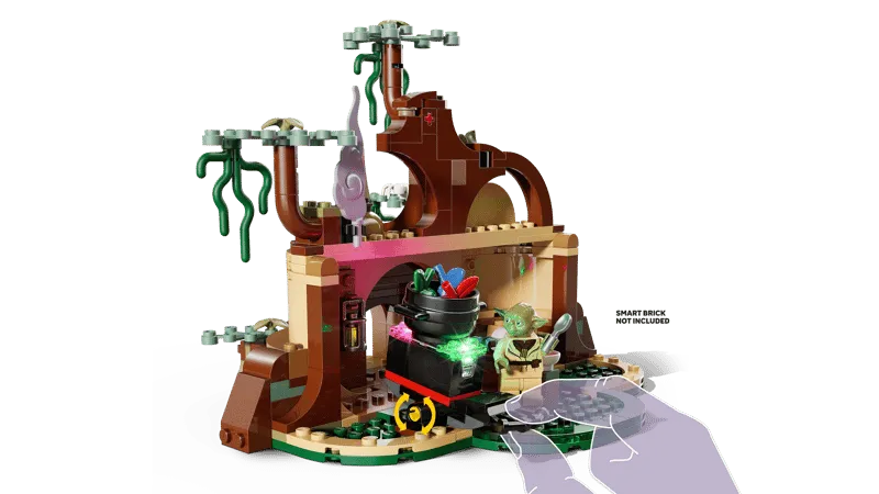 A hand interacting with the cauldron in Yoda's hut from the Lego SMART Play™: Yoda's Hut and Jedi Training 75422 set, highlighting the 'Smart Brick Not Included' feature.