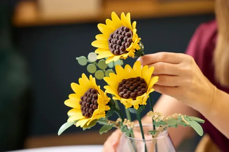 Arranging LEGO sunflowers in a vase