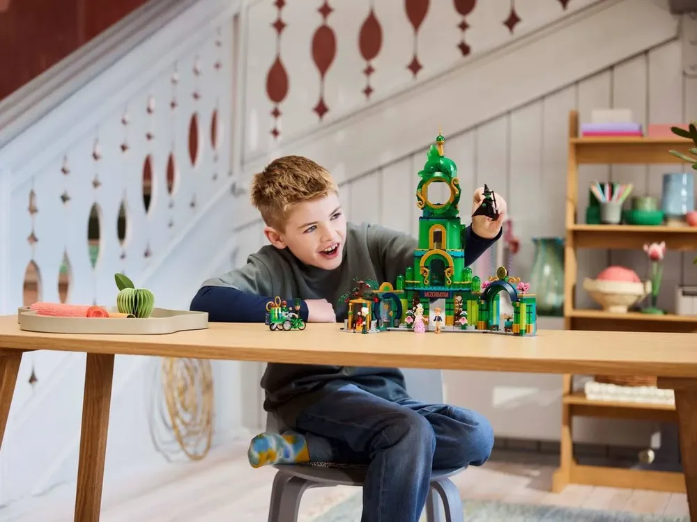 Boy playing with Lego Emerald City 75684.