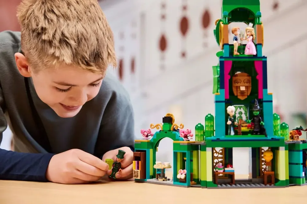 Boy smiling while playing with Lego Emerald City.