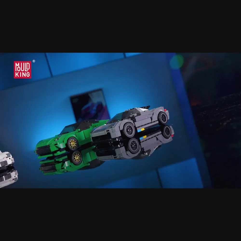 Two brick-built sports cars, green and grey, on a reflective surface.