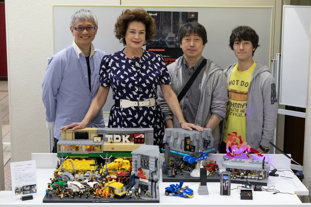 LEGO MOC artist Keiichi Kamei poses with his Blade Runner diorama alongside actress Sean Young