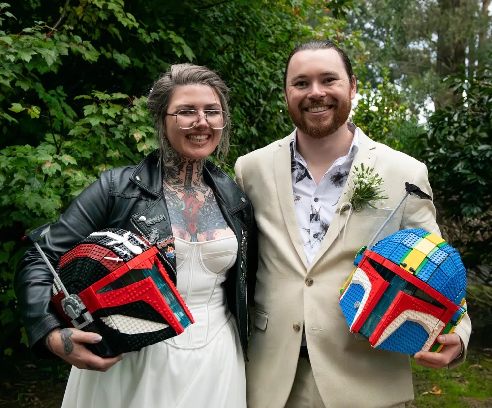 Artist Lewis Meeny and his wife Sarah with LEGOlorian helmets on their wedding day