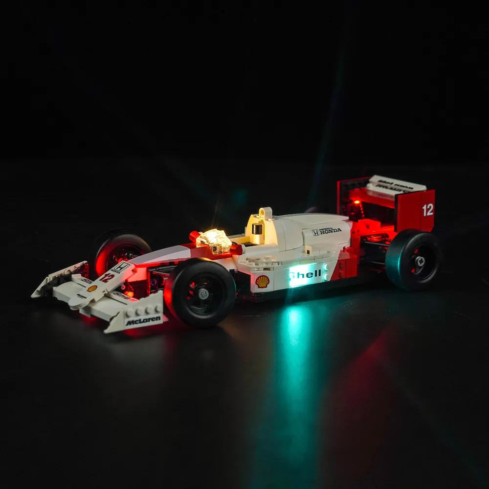 BrickBling LED kit for LEGO McLaren MP4/4 highlighting the engine bay and Senna minifigure under warm white glow