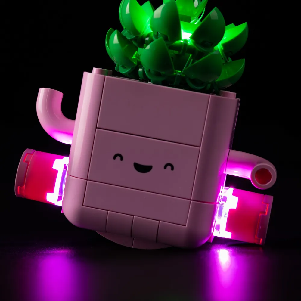 Game of Bricks lit LEGO Rocking Plants on a desk, glowing warmly