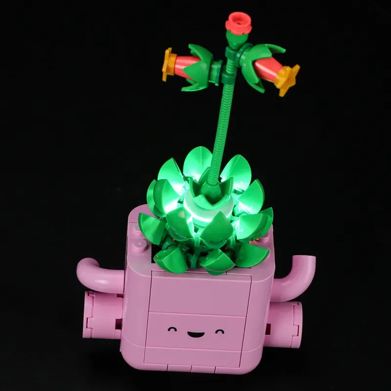 Lightailing lit LEGO Rocking Plants on a bookshelf, cozy glow