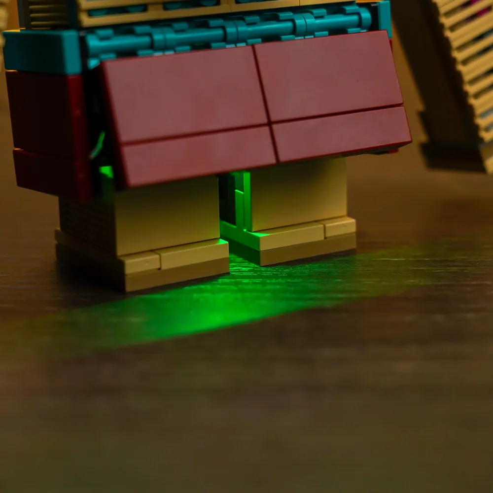 LEGO 21257 with BrickBling lighting in a display, showcasing the glowing magenta accents at night