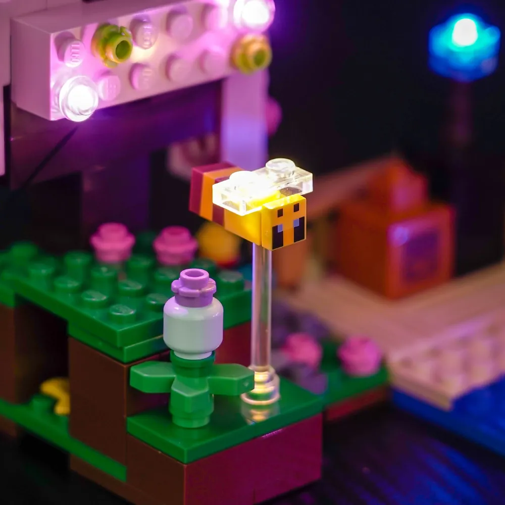 Minecraft cherry blossom garden illuminated at night with warm LEDs