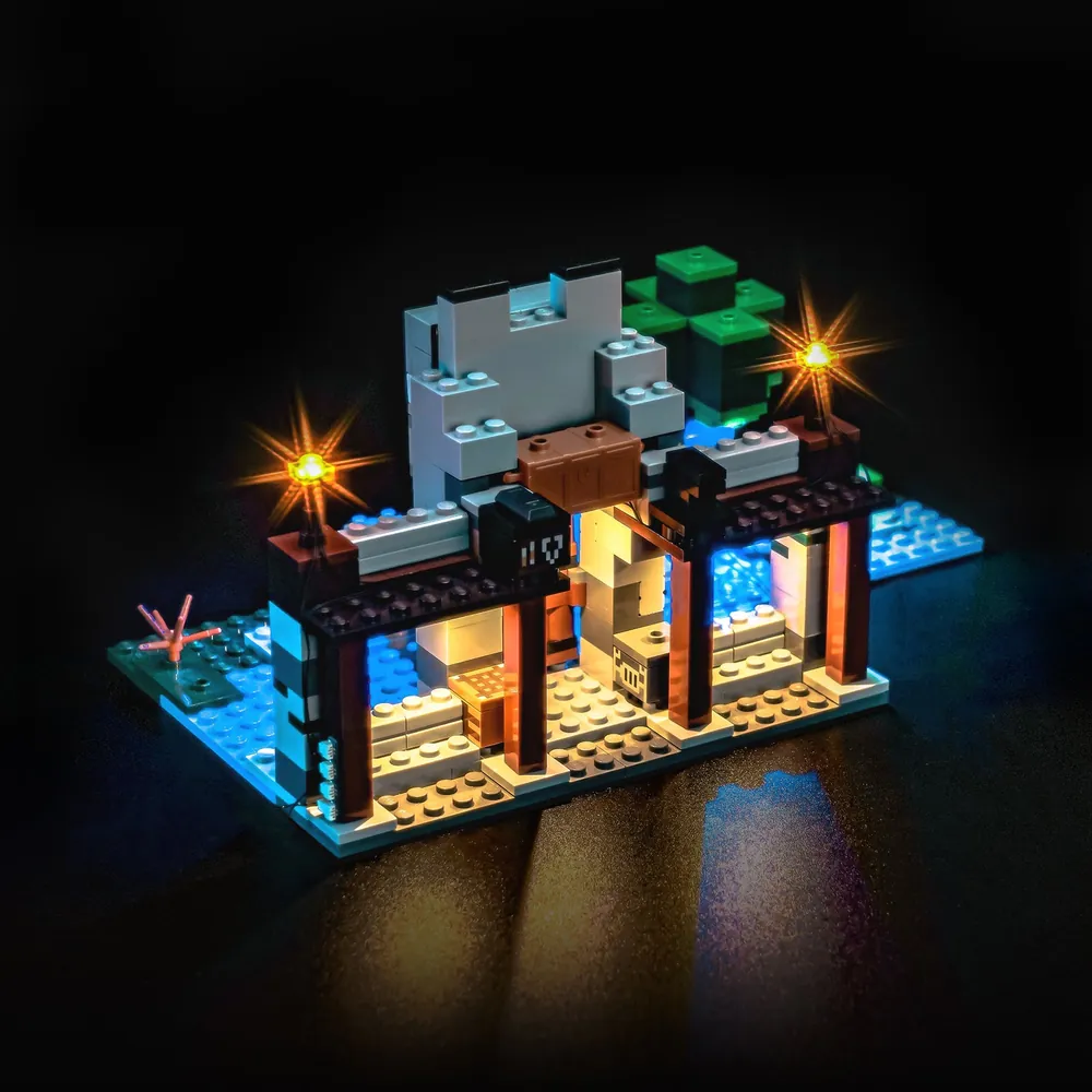 The Wolf Stronghold 21261 with BrickBling lighting in a dark room