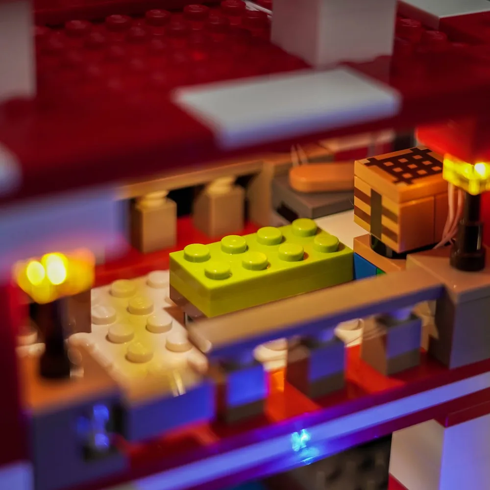 Close-up of BrickBling modular micro-LEDs and thin wires on the LEGO Mooshroom House set.