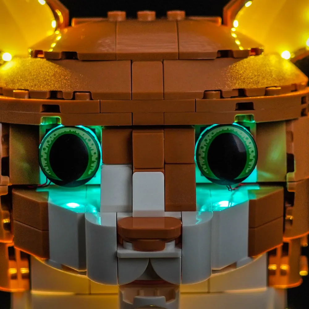 Close-up of a BrickBling micro-LED tucked into a brick gap on the LEGO cat