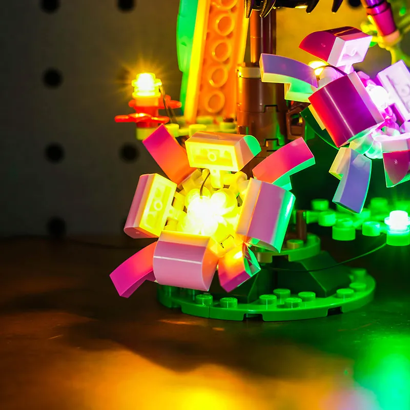 Close-up of modular micro-LEDs on LEGO parrot wing illuminating SNOT curves