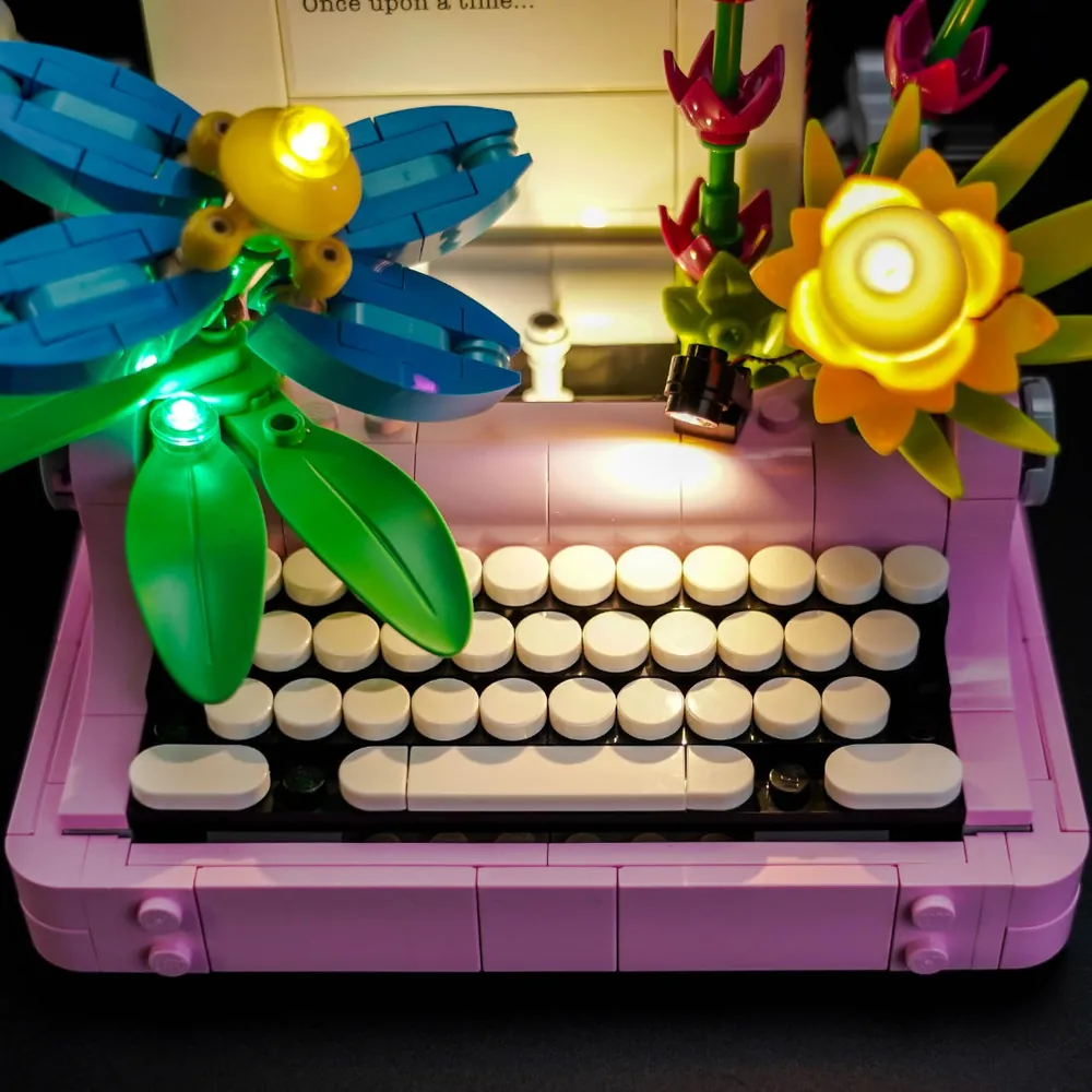 Close-up of BrickBling micro-LEDs illuminating the keyboard and flower petals on LEGO 31169