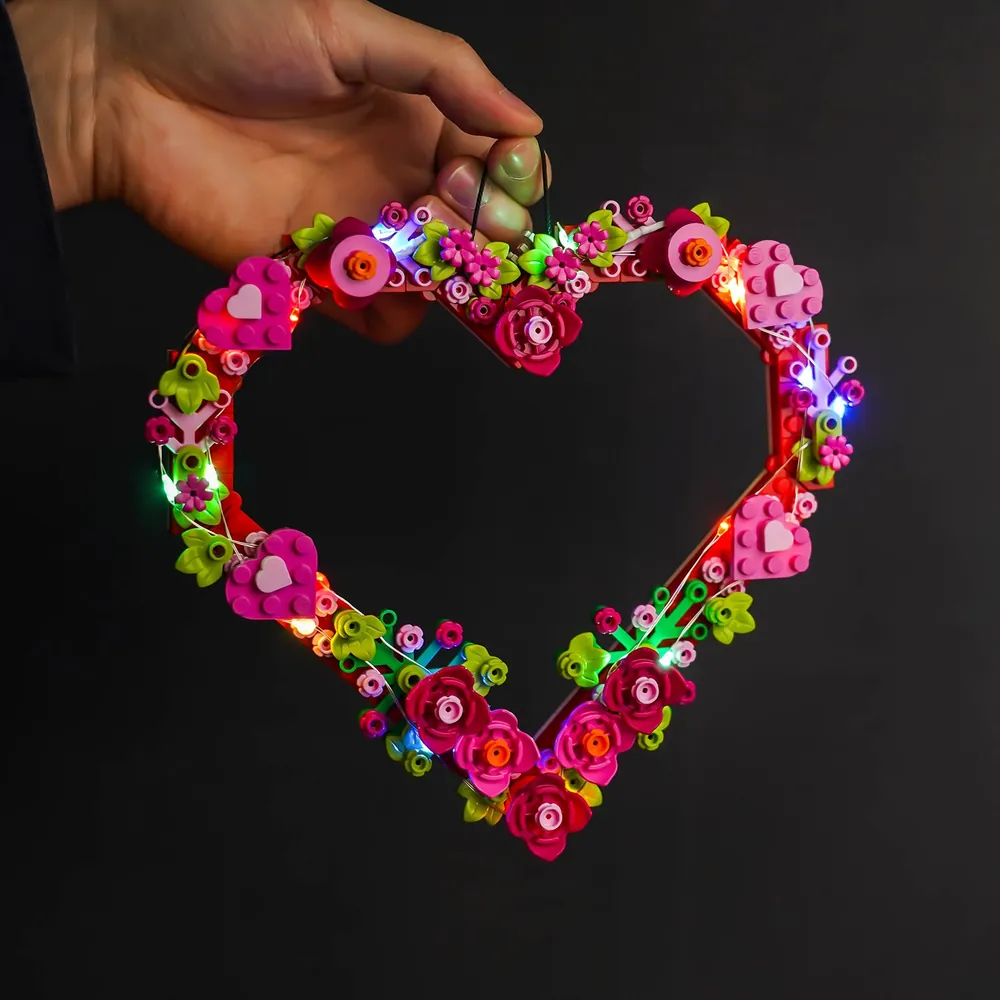 LEGO Heart Ornament 40638 with BrickBling lights displayed against wooden background