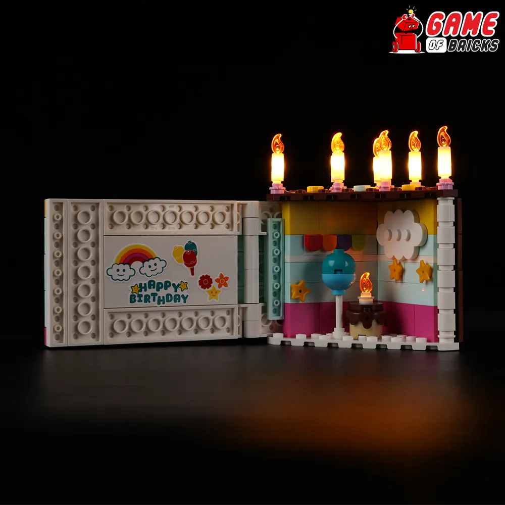 LEGO Birthday Cake 40641 fully lit with Game of Bricks, showing slide and interior lights