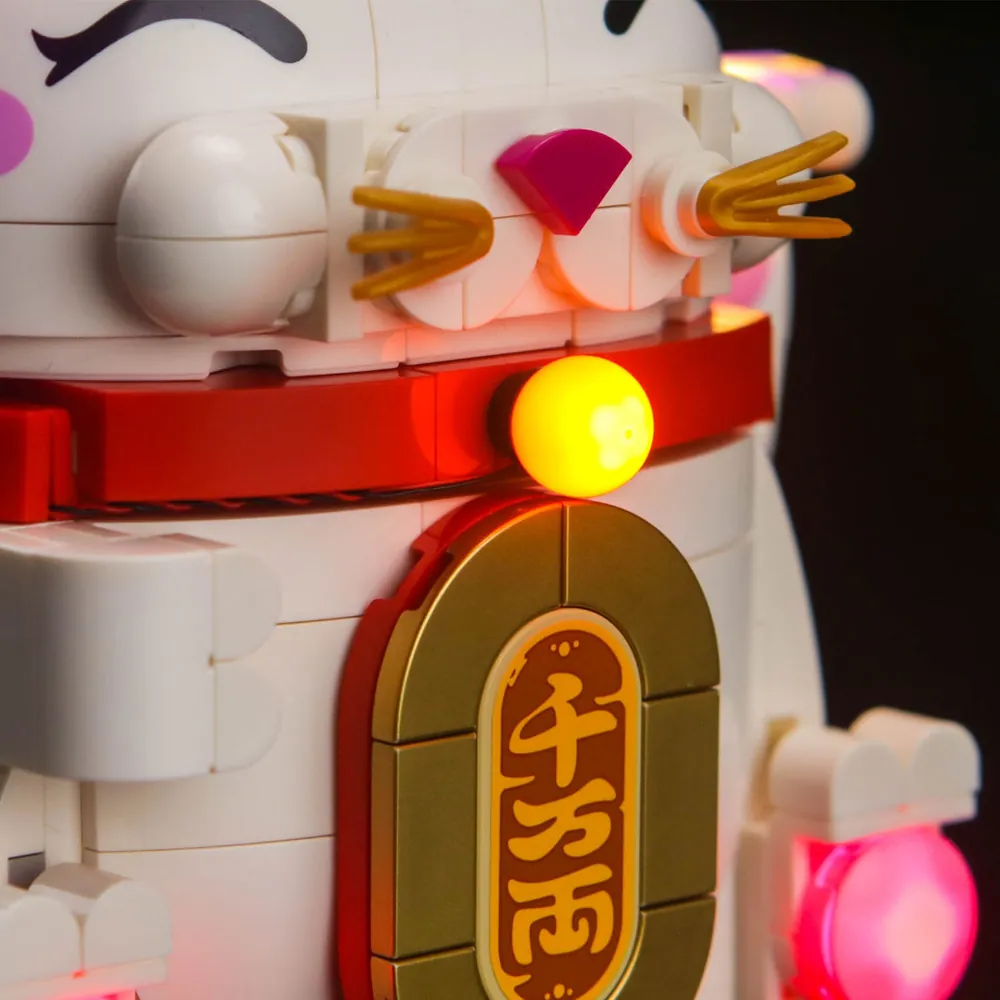 Close-up of golden coin lit by BrickBling micro-LEDs on LEGO Lucky Cat