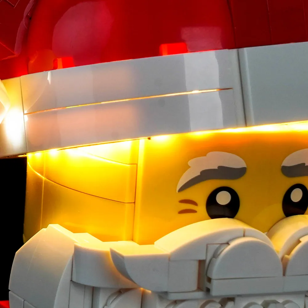 Close-up of BrickBling micro-LEDs illuminating Santa's face and beard on LEGO 40820