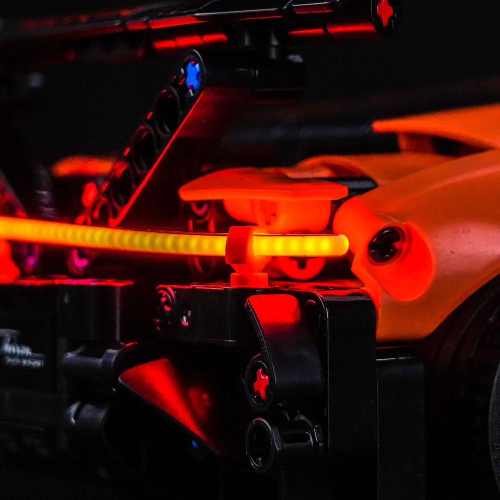 Close-up of BrickBling modular micro-LED wires hidden along LEGO Technic Bugatti chassis
