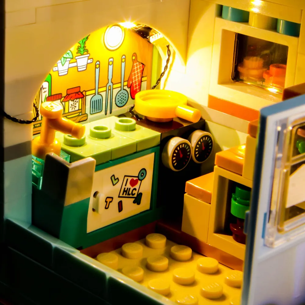 Close-up of BrickBling modular micro-LED wiring on the LEGO Friends Camper Van, showing clean concealment around the roof and chassis.