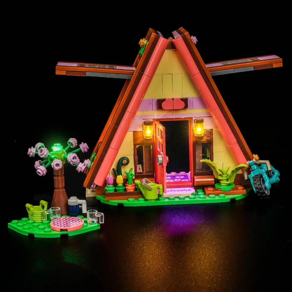 BrickBling LED kit lighting the LEGO Friends Nature Glamping Cabin 42682 interior with warm glow