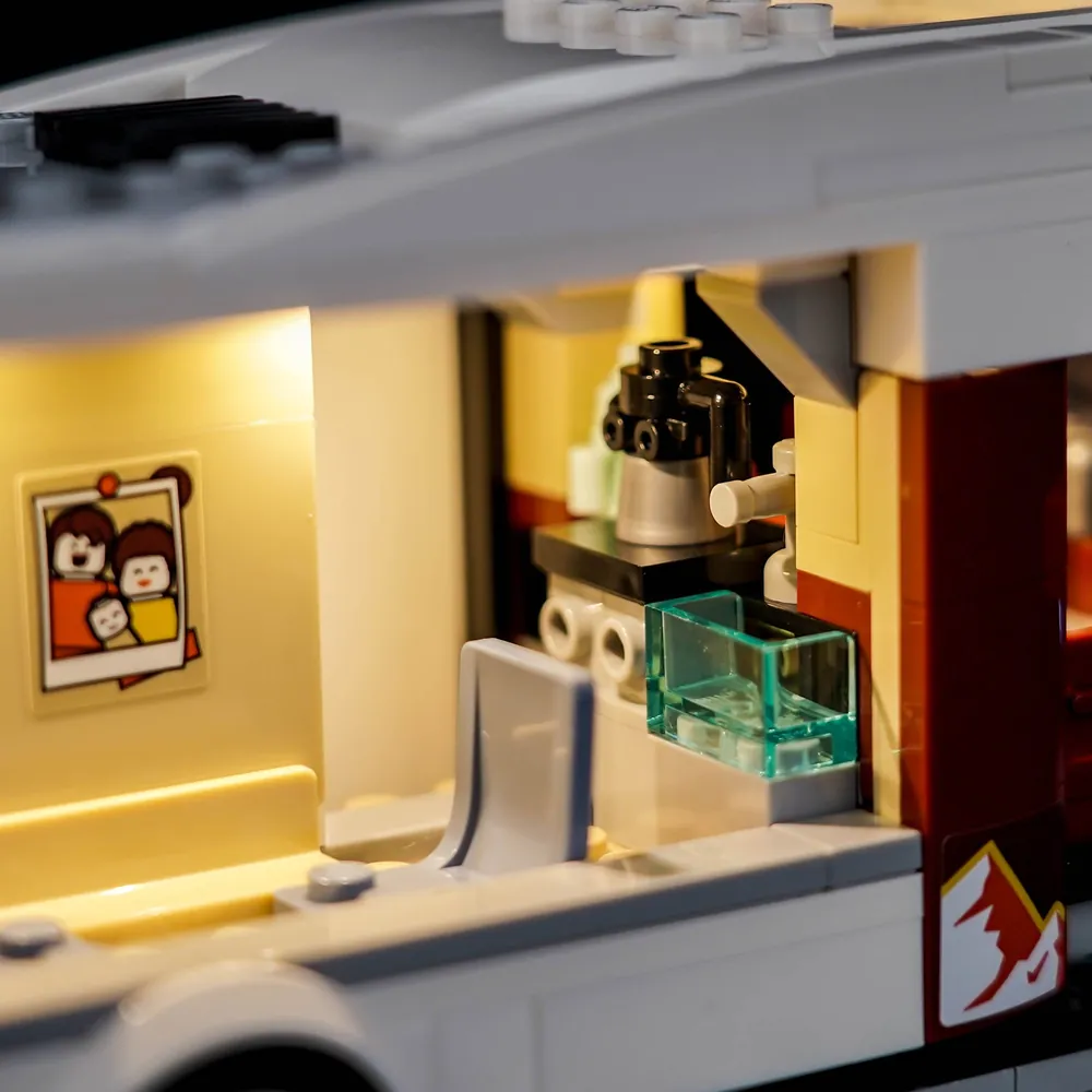 Close-up of mini LEDs hidden in the LEGO camper van highlighting the campfire and guitar scene