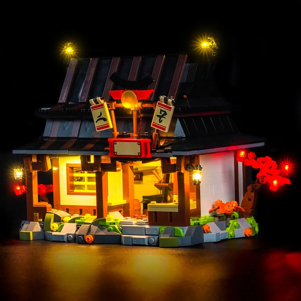 BrickBling light kit for LEGO Ninjago 71858 Four Weapons Blacksmith with modular micro-LEDs illuminating the forge and interior.