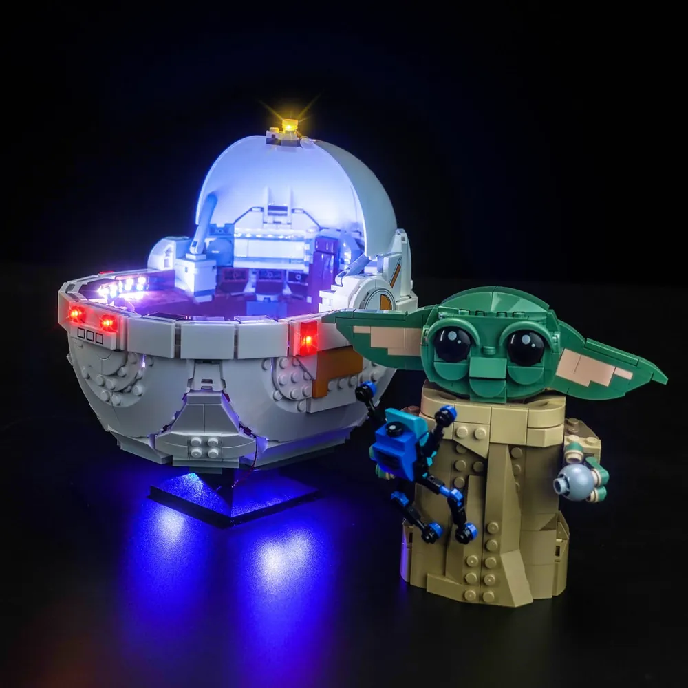 LEGO Grogu 75403 with BrickBling lights in a dark display