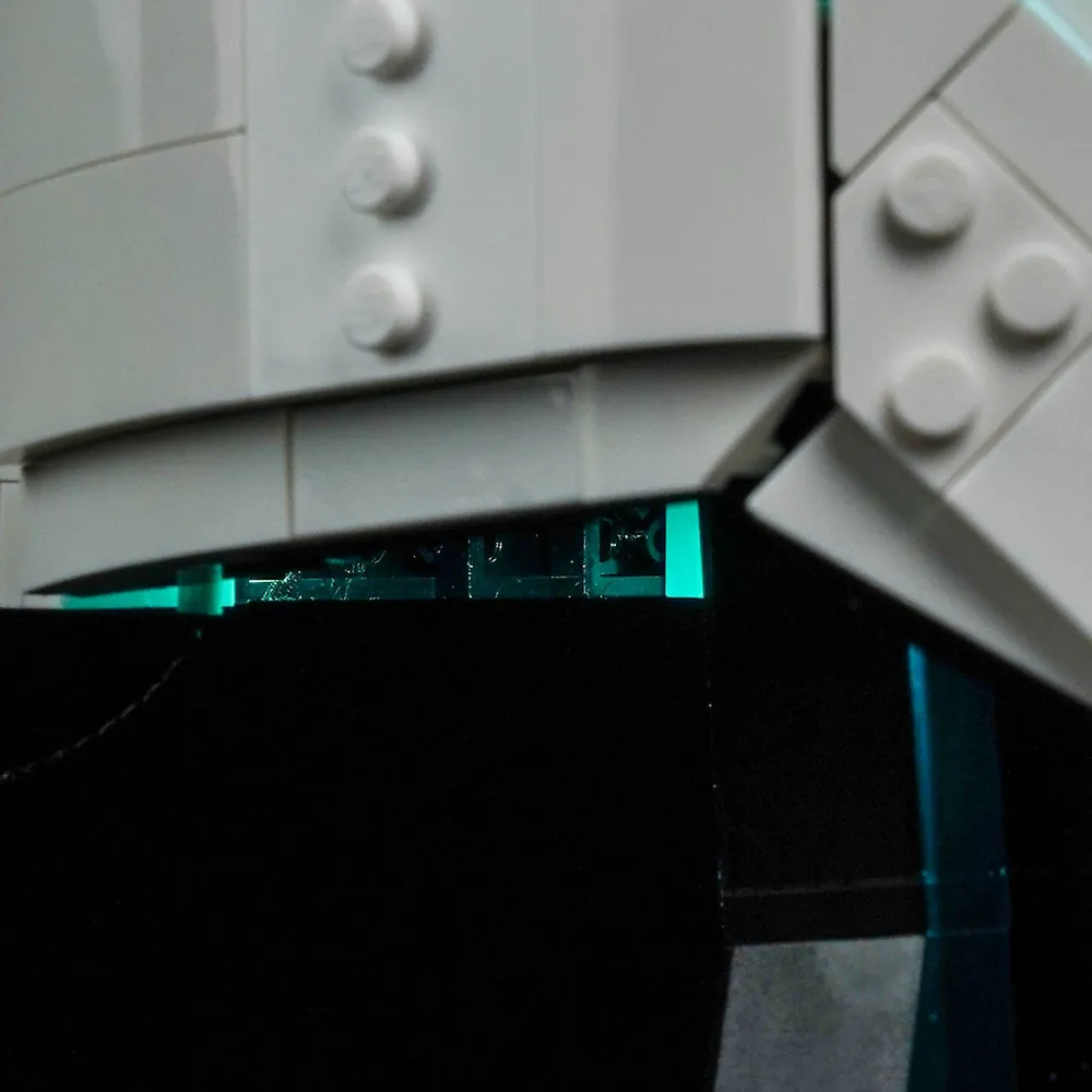 White and tan LEGO AT-RT Driver Helmet with BrickBling light-control remote mounted beside the build