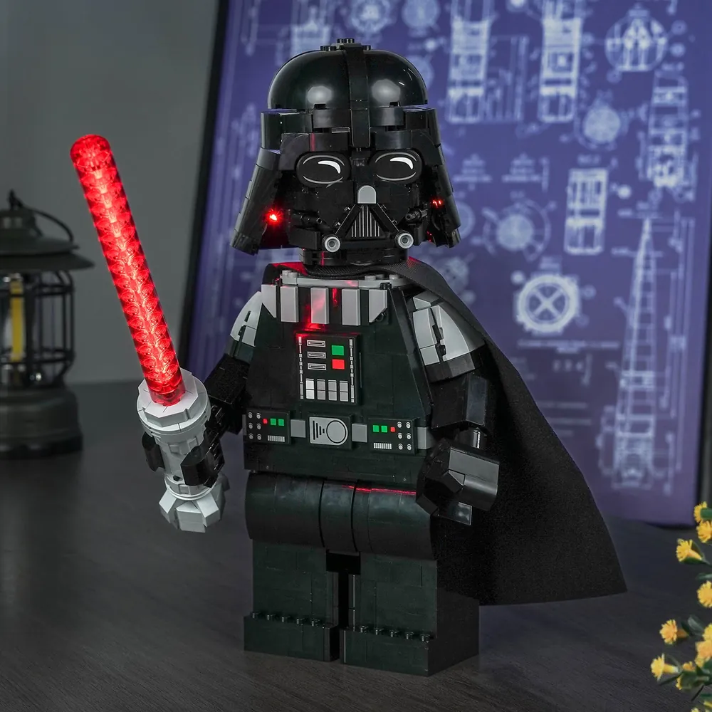 BrickBling illuminated Darth Vader display with saber glow in a dark room