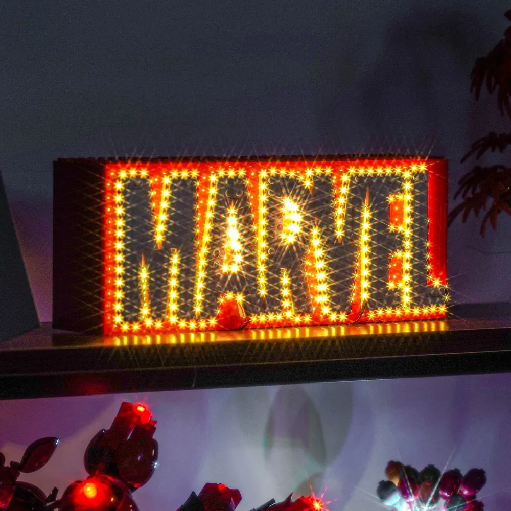 Wide shot of MARVEL logo display with BrickBling lighting and minifigures