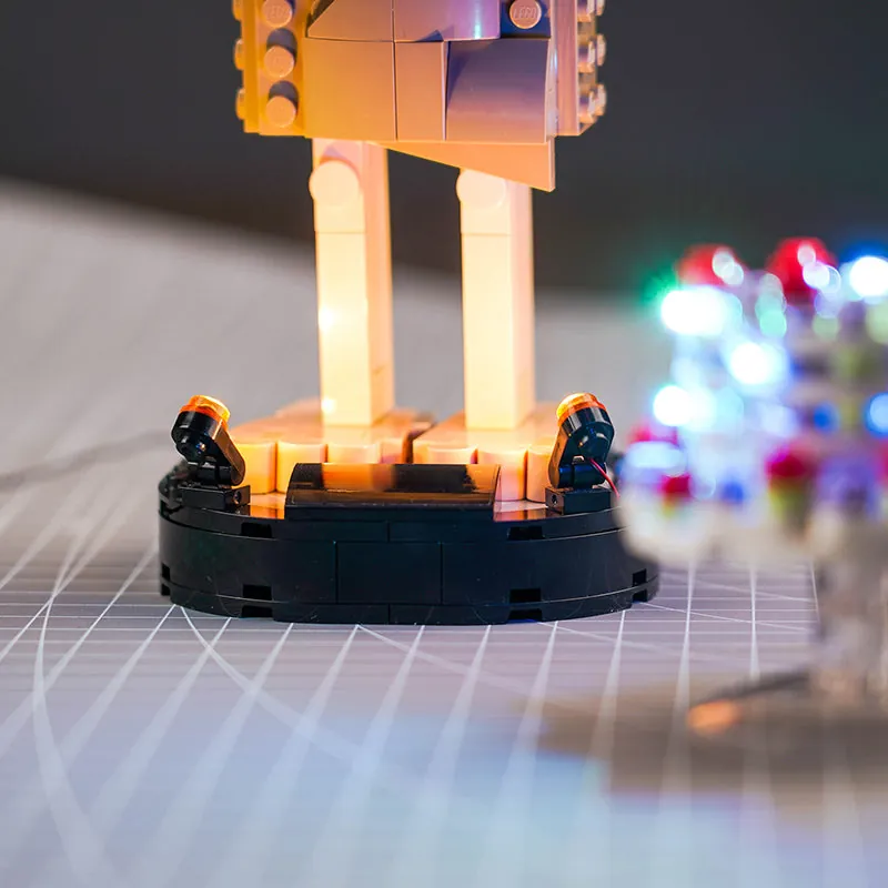 LEGO Dobby lit by BrickBling kit in a display, showing soft glow on accessories