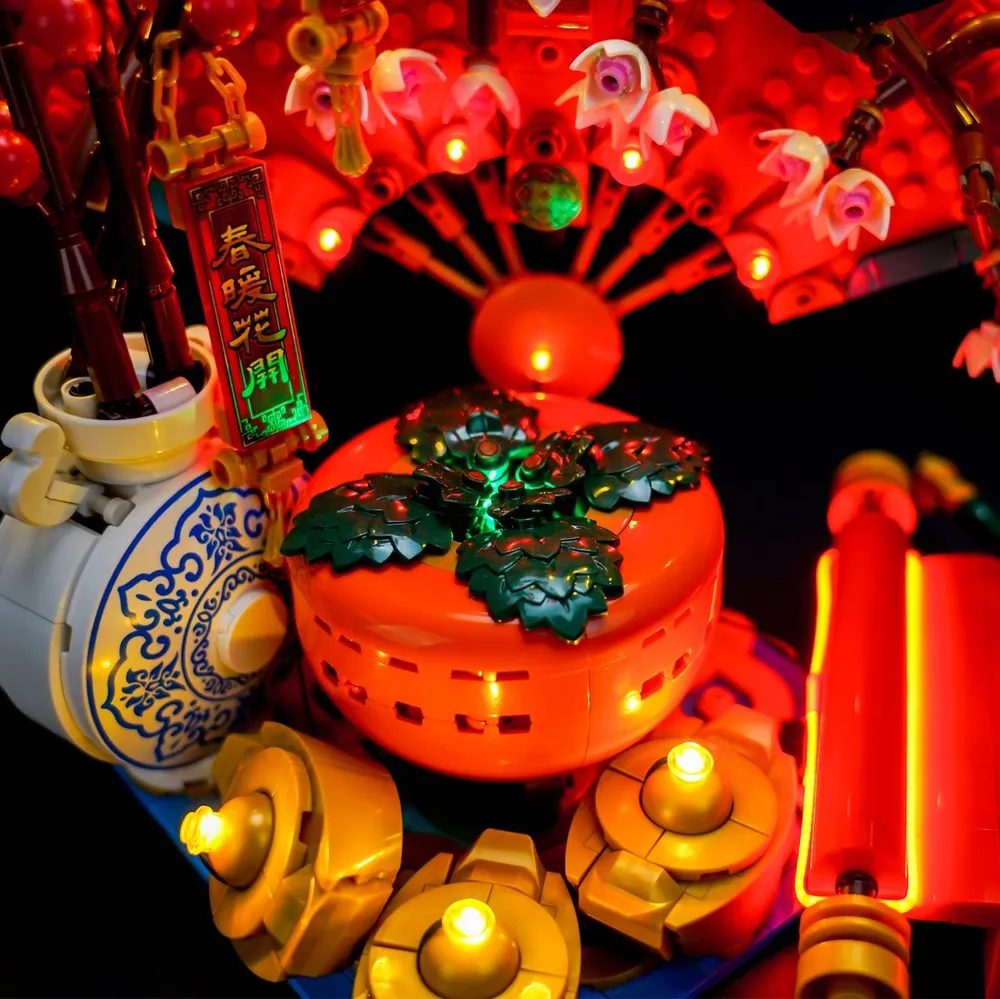 Close-up of BrickBling micro-LEDs illuminating cherry blossom fan and ingots on LEGO 80117