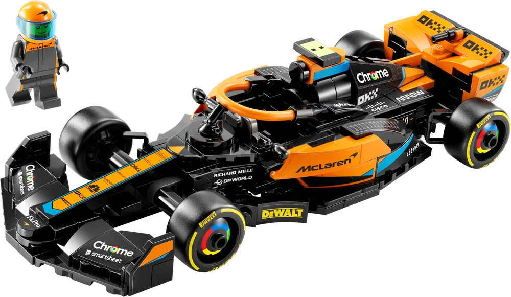 A LEGO McLaren Formula 1 race car, mostly orange and black, with a minifigure in an orange helmet standing next to it.