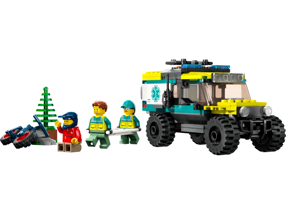 A LEGO City 4x4 Off-Road Ambulance Rescue set 40582 is displayed against a white background. The vehicle features large rugged tires, lime green and dark azure accents, and an ambulance insignia. Two paramedics hold a white stretcher with an injured minifigure, and a broken red dirt bike lies near a green LEGO tree.