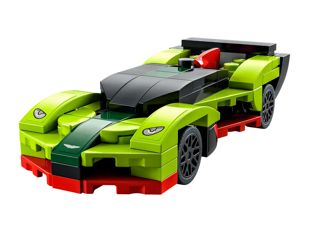 A detailed close-up of the LEGO Speed Champions Aston Martin Valkyrie AMR Pro, featuring its lime green, black, and red color scheme. The car has smooth tile elements on the central hood and cockpit, with exposed studs along the side fenders and a small red seat visible.