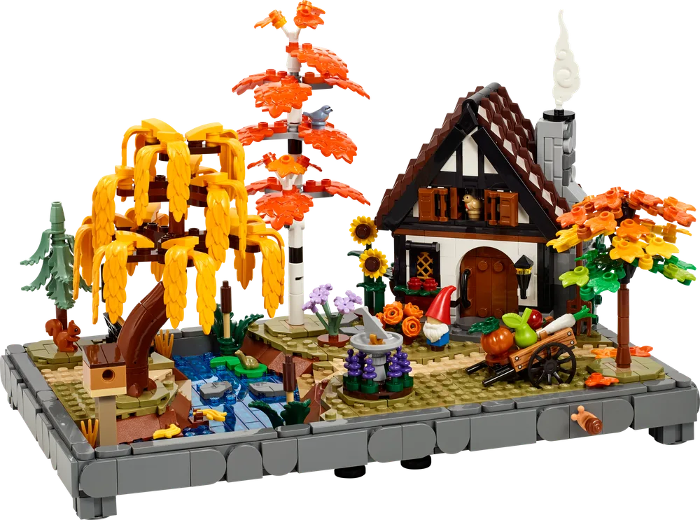 Full view of the LEGO Autumn Cottage Garden set, showcasing a cottage with a vibrant autumn landscape including a weeping willow, a stream, and various small details.