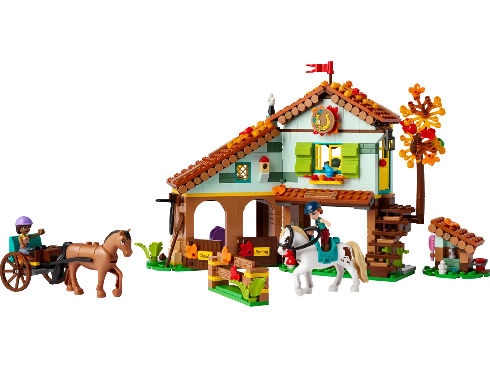 Full view of LEGO Friends Autumn's Horse Stable set 41745 with Autumn in a horse-drawn cart and Aliya riding a white horse.