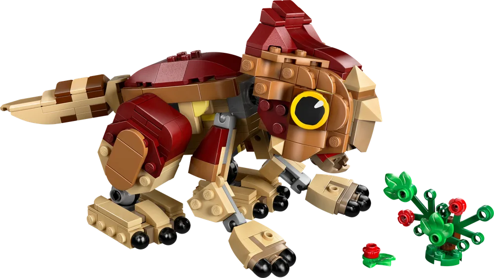 A LEGO build of a small, reddish-brown dinosaur, Aquilops, with large yellow eyes, shown from a slightly elevated side angle, next to a small green plant with red berries.