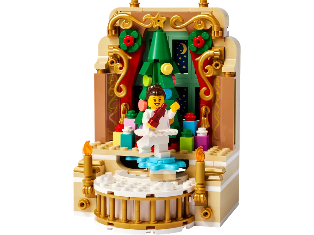 Front view of the LEGO Ballerina & Nutcracker Scene build, featuring a ballerina on a snowflake-shaped stage, a Christmas tree, and golden ornate arches.