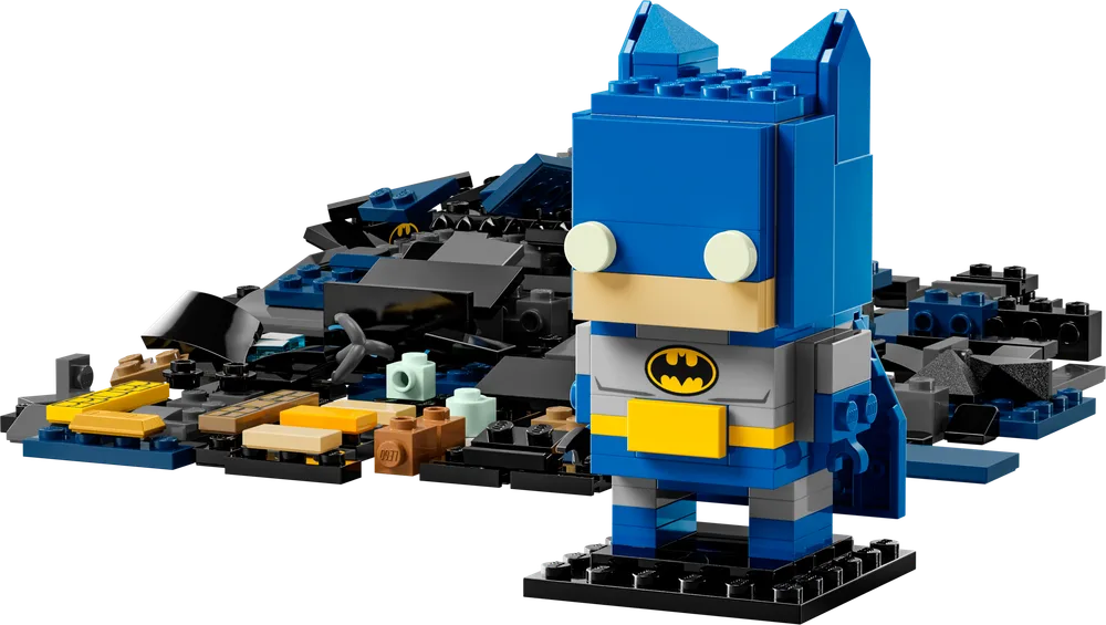 LEGO BrickHeadz 8-in-1 Batman figure in blue, with a pile of black, grey, blue, and tan LEGO bricks behind it.